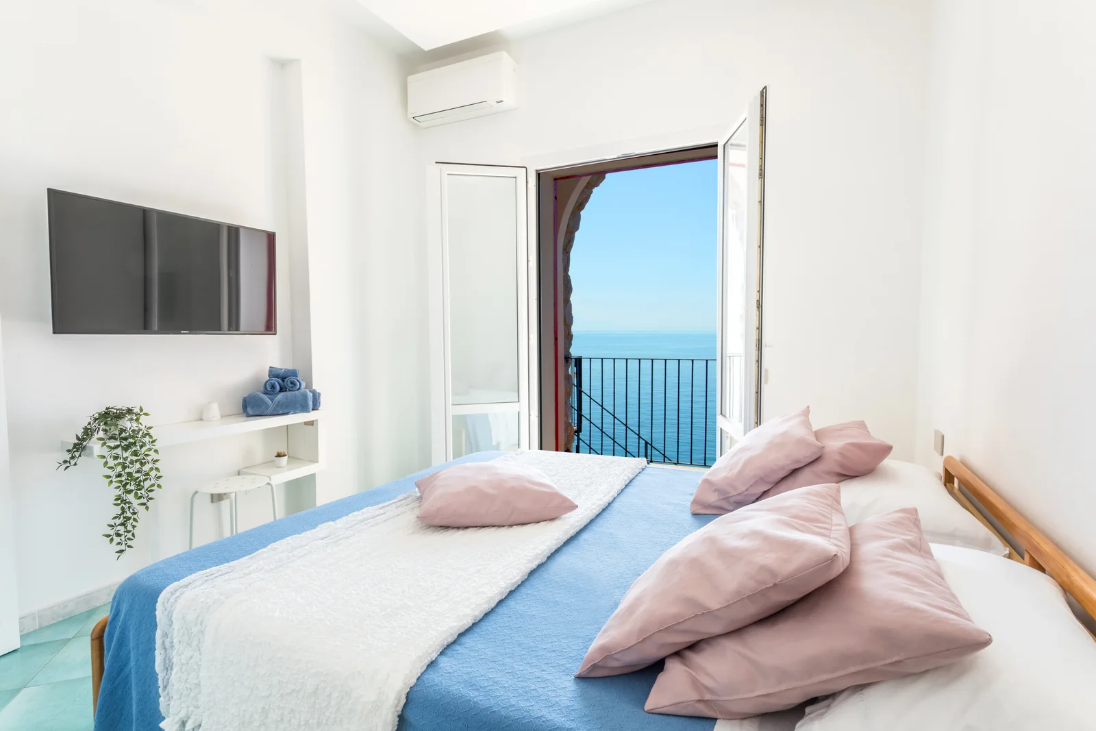 Bright double bedroom with a sea view